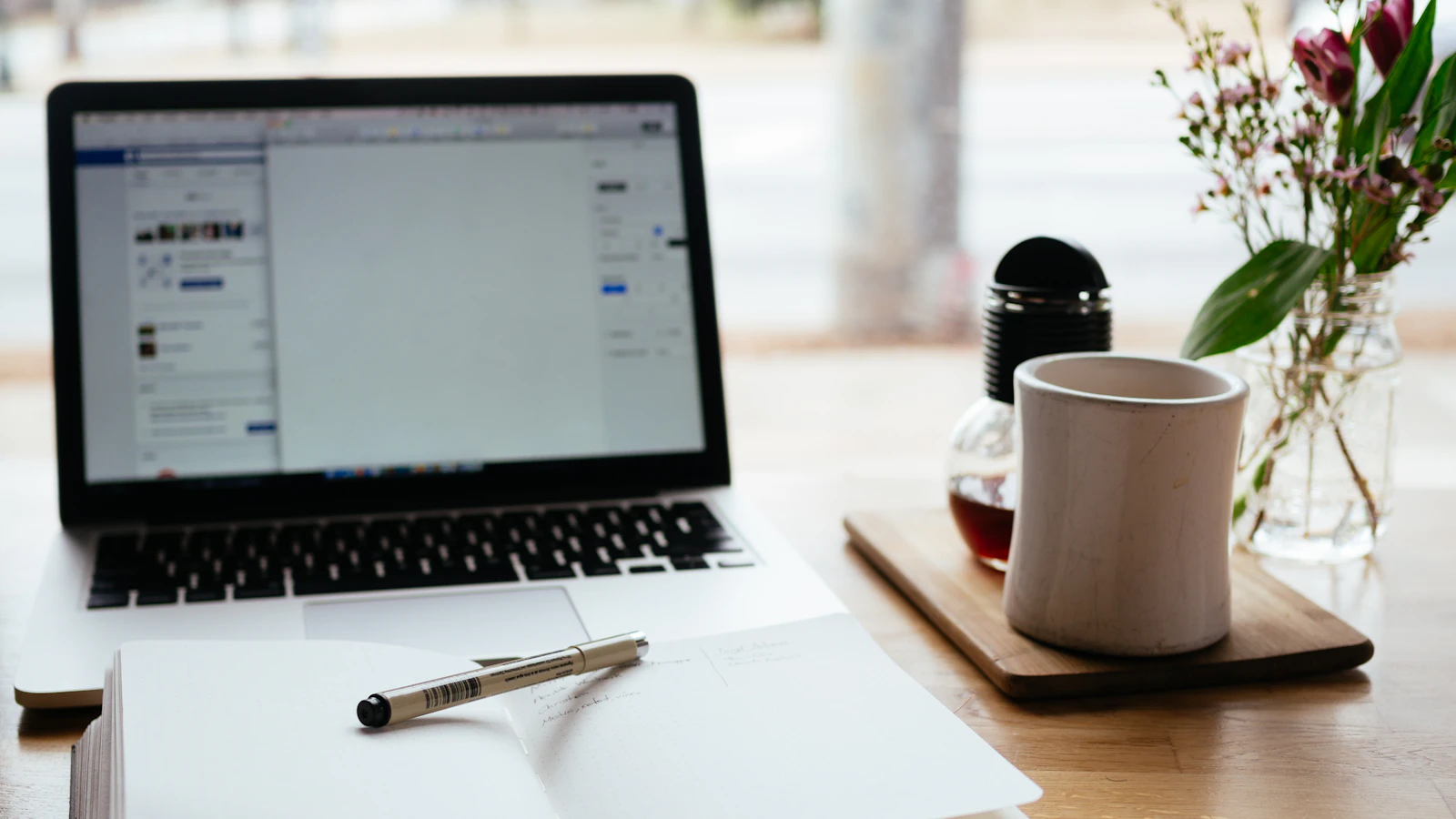 Laptop and notebook used for website content planning in Leicestershire